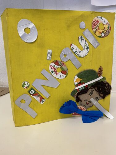 • Capa do livro “O Pinóquio” com os recortes das embalagens Tetra Pak da marca Compal, com referência à marca Compal, Tetra Pak e FSC.